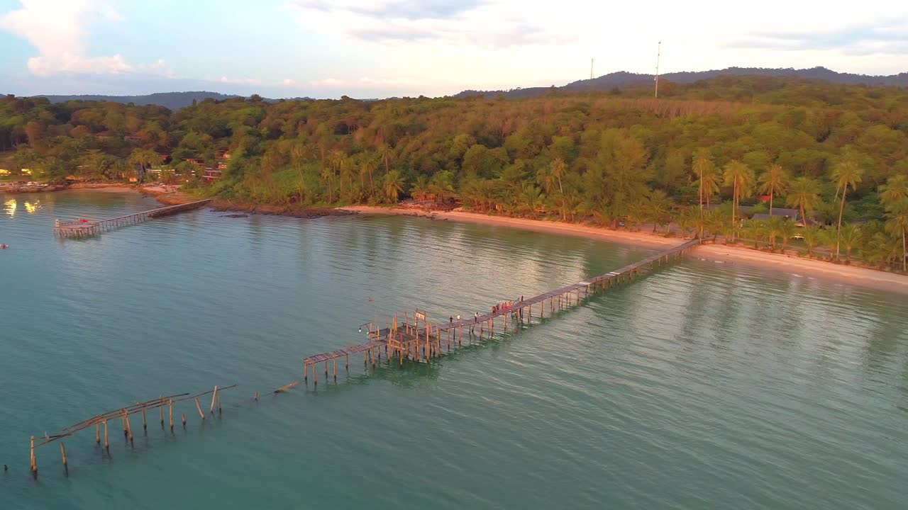 Stunning Aerial View of a Tropical Beach with a Wooden Pier