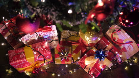 christmas gifts and decorated tree with colorful light during xmas night celebration