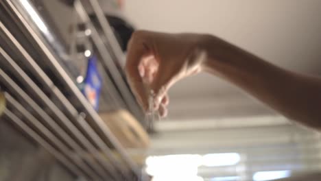 hand of a baker in the kitchen sprinkling flour - close up slowmo