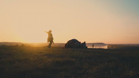 silhouette of plump girl dancing near friends at sunset