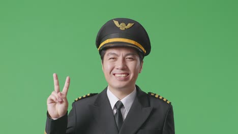 pilot smiling and showing peace sign