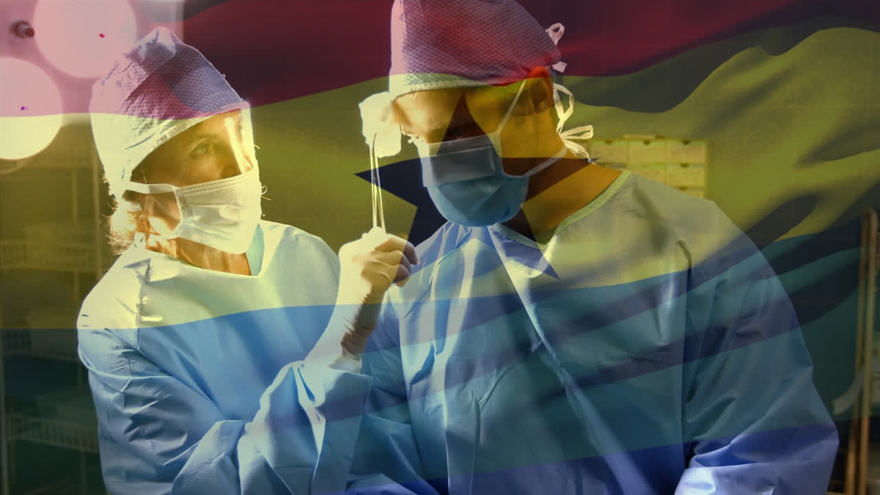Animation of flag of ghana waving over surgeons in operating theatre