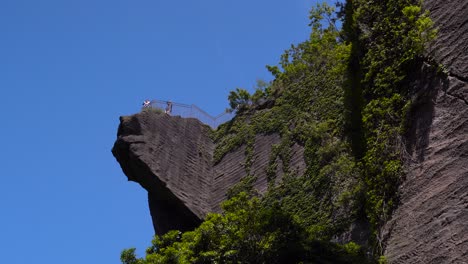 Tourists-Taking-Pictures-At-The-Observation-Deck-View-Point-With-The-Hell-View-Of-Mount-Nokogiriyama-In-Honshu,-Japan---low-angle-shot