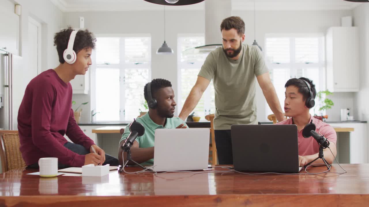 Happy diverse male friends talking and recording in living room