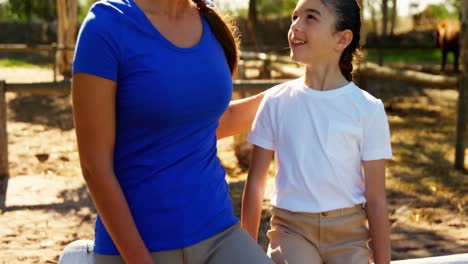 mother and daughter interacting with each other in ranch 4k