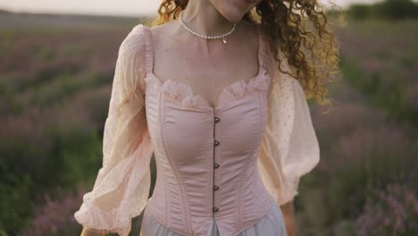 woman in a pink dress running joyfully through a lavender field