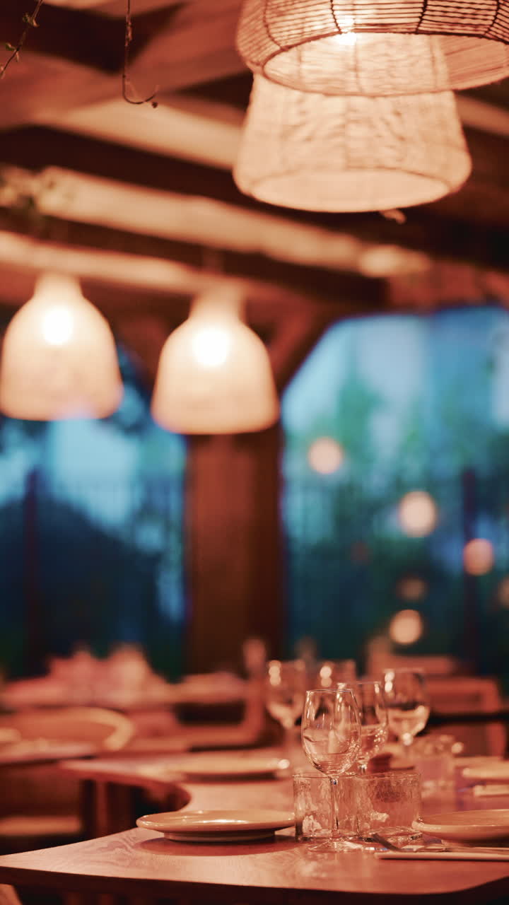 Woman with long wavy hair, viewed from behind as she looks at pastries through the display glass. Vertical