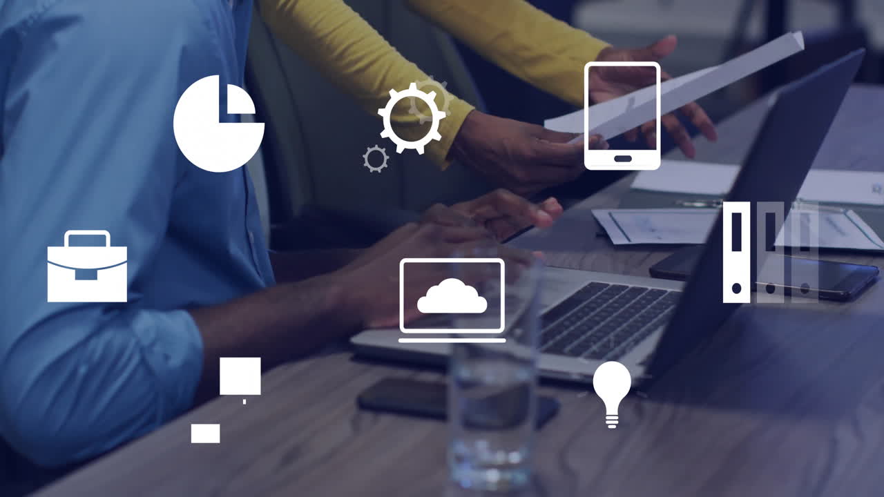 Business icons animation over people working with laptops and tablets in office
