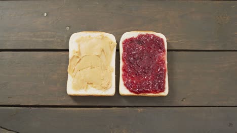 Close-up-view-of-peanut-butter-and-jelly-sandwich-with-copy-space-on-wooden-surface