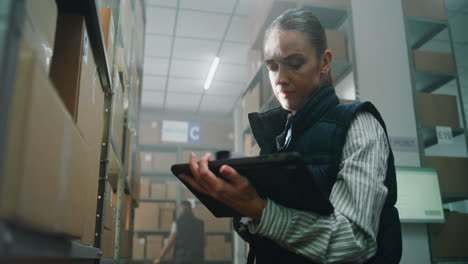 warehouse worker using a tablet for inventory management