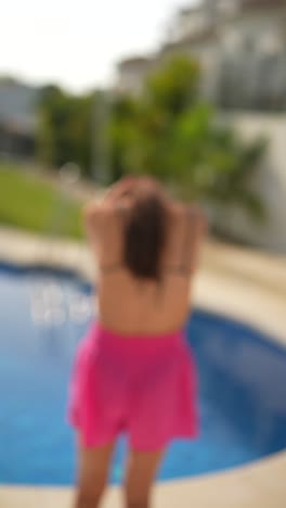 woman relaxing by a swimming pool