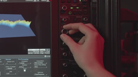 hand adjusting equalizers, dj mixing music on an audio mixer