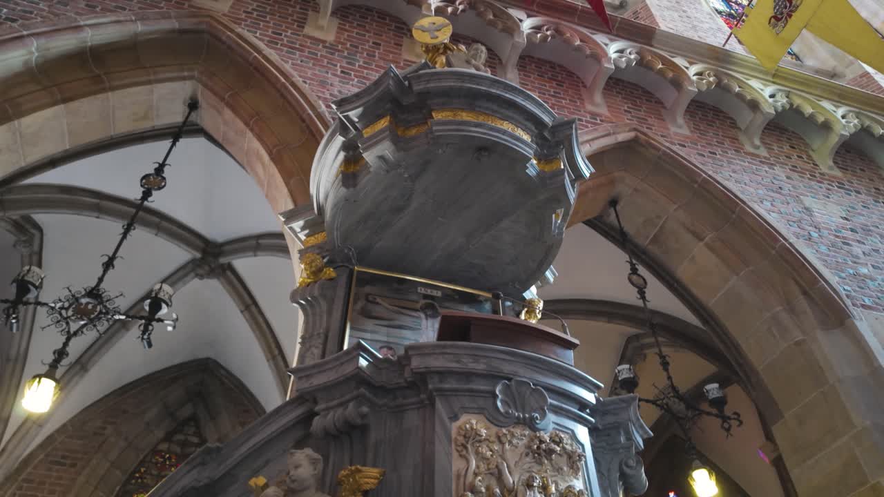Intricately carved pulpit inside the Cathedral of St. John the Baptist, showcasing detailed sculptures and beautiful craftsmanship.