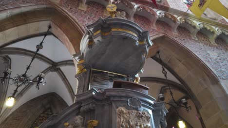 intricately carved pulpit inside the cathedral of st. john the baptist, showcasing detailed sculptures and beautiful craftsmanship.