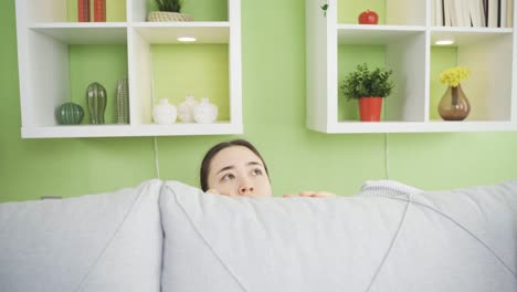 young asian woman hiding and shivering feeling danger and fear. agoraphobia.