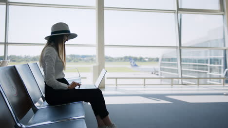 woman working on laptop in airport