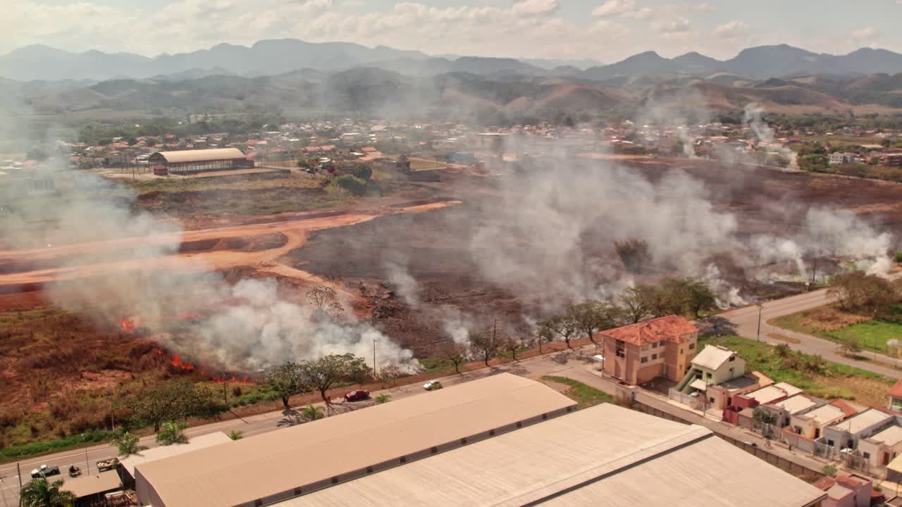 Aerial view of a wildfire burning near a town