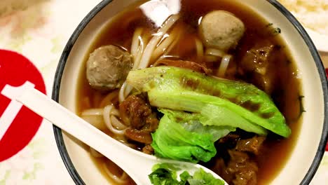 a bowl of noodle soup with vegetables