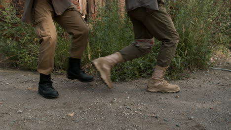 men with guns around an abandoned house