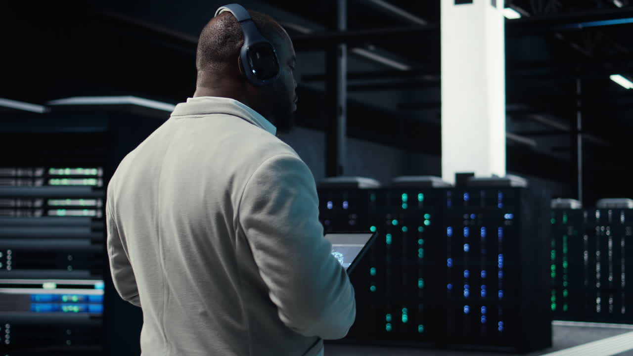 Vertical video Software developer in data center workspace coding on tablet