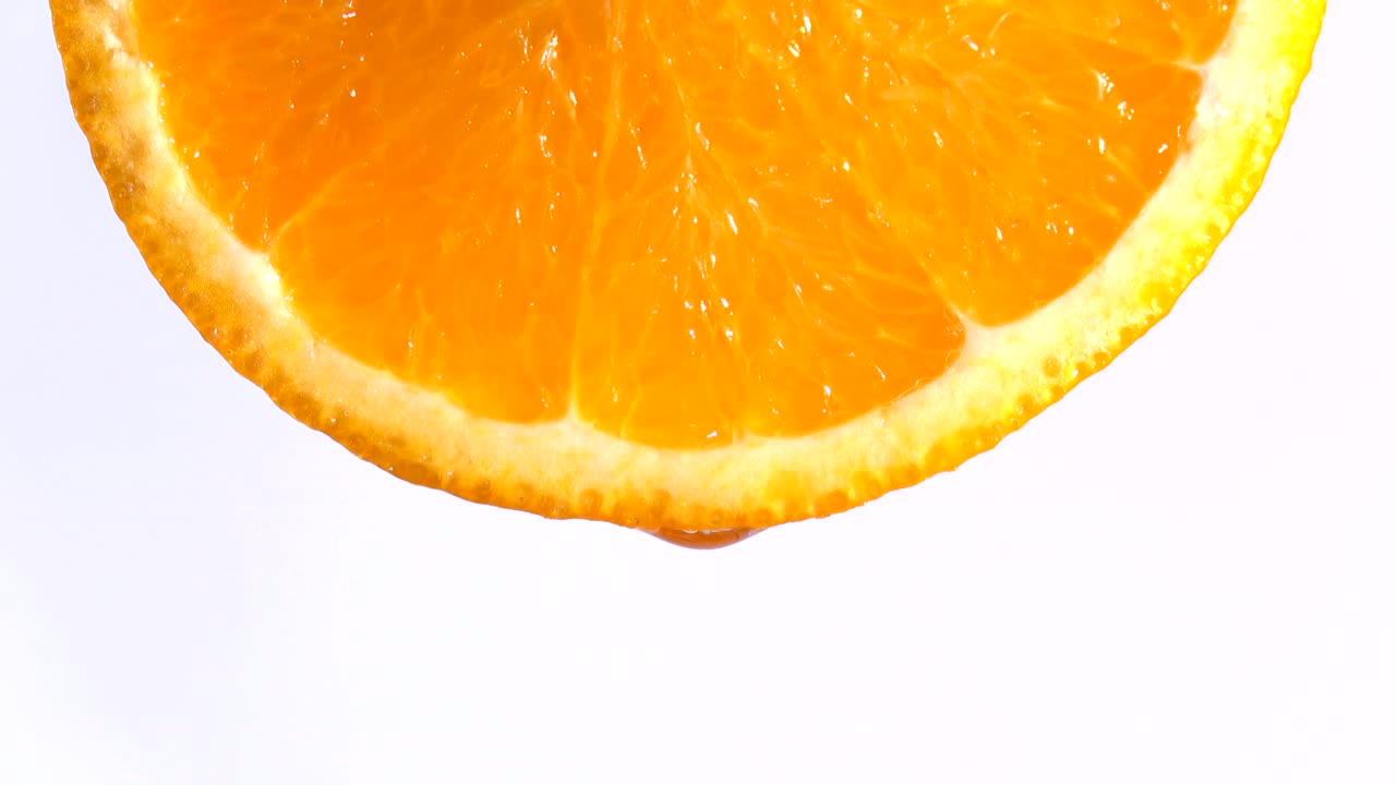 Water or oils dropping on an orange slice , fruit for diet and healthy food