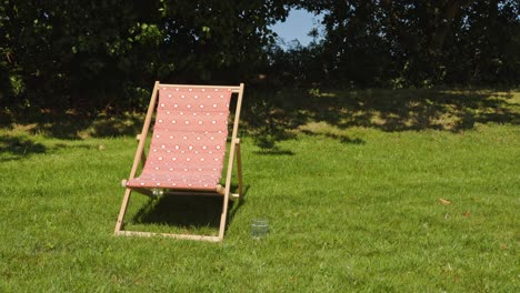 sun loungers on a fresh green lawn. a beautiful summer day concept