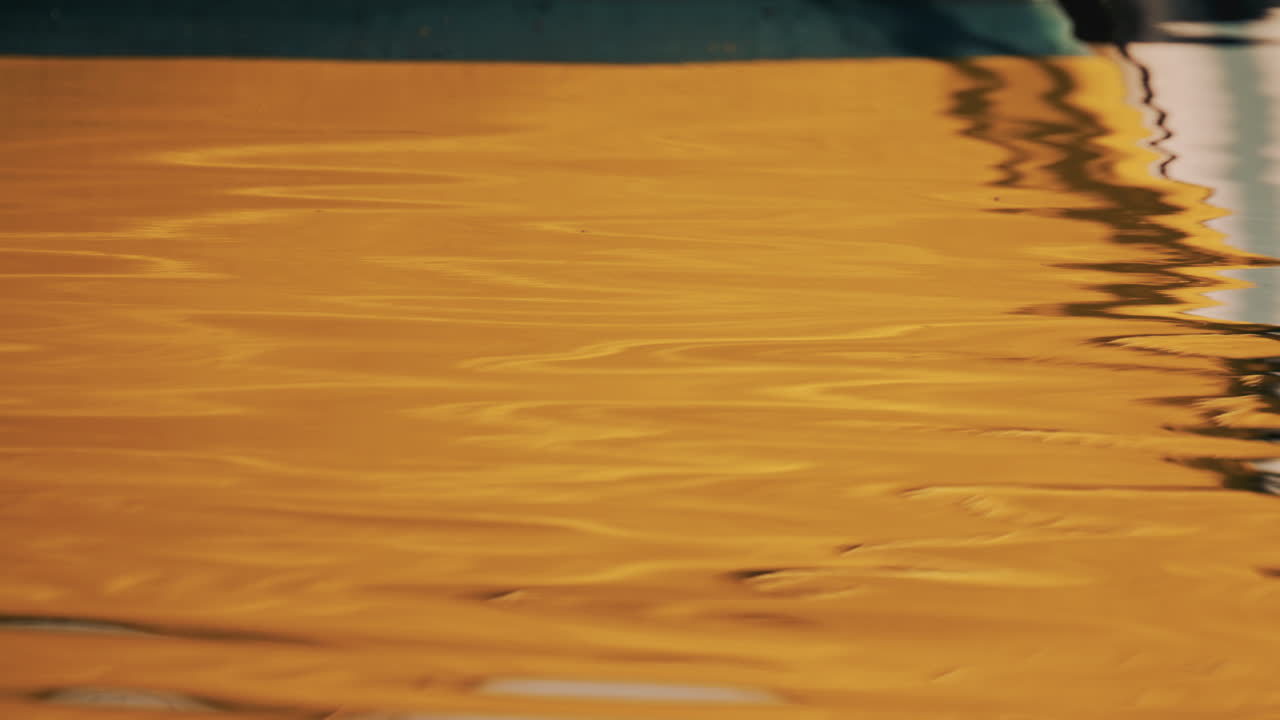 Abstract close up of a yellow boat reflection on the water
