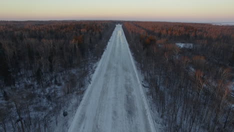 aerial view of empty road in winter woods