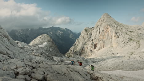 Hikers-climbing-on-a-mountain,-vast-landscape-of-mountain-rocks,-desolated-place