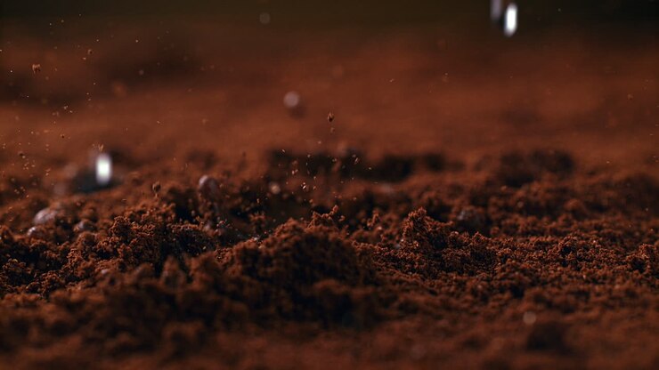 Brewing Powdered Arabica By Pouring Hot Water Onto Ground Coffee Beans In Macro and Slow Motion