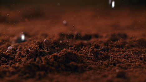 brewing powdered arabica by pouring hot water onto ground coffee beans in macro and slow motion