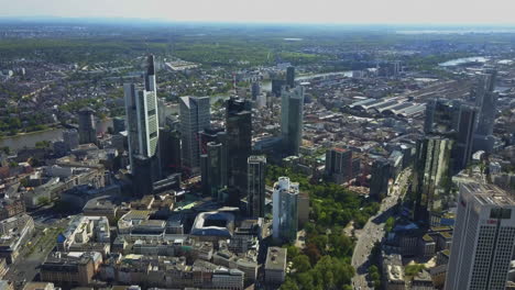 AERIAL-Above-Frankfurt-am-Main-with-Drone-looking-down-on-Skyscrapers-in-Beautiful-Summer-Sunshine