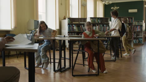 children preparing for class in a school library or classroom