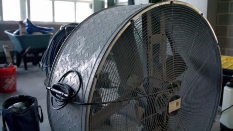 industrial fan in a warehouse dolly right to left