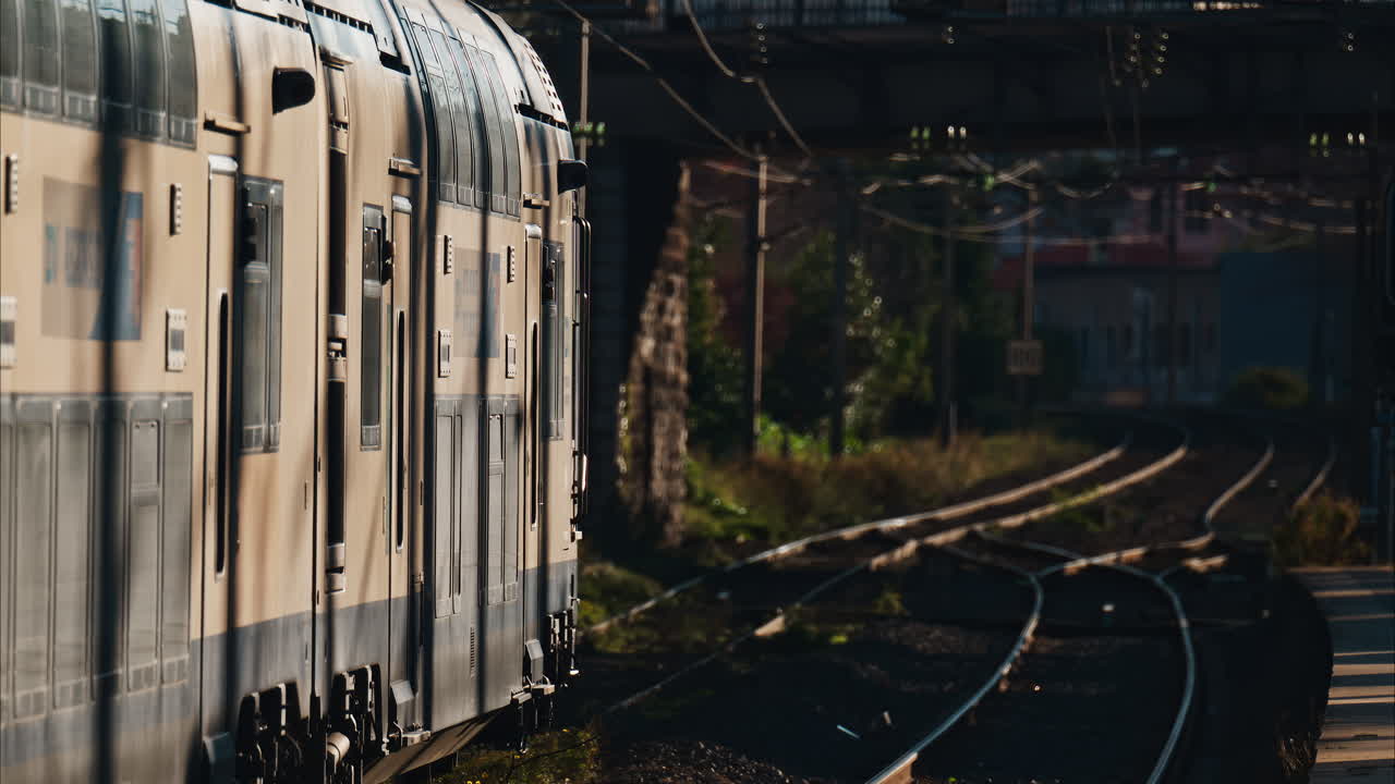 Close up of a train moving on the rails near a station in the south of France at sunset