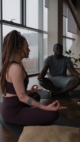 couple meditating in a modern yoga studio
