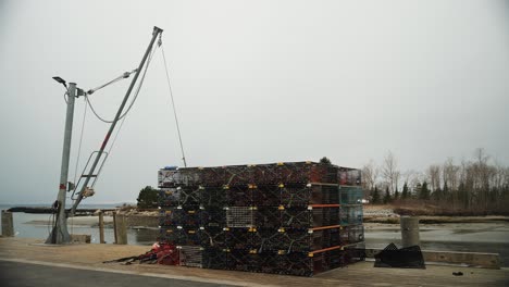 Lobster-fishing-traps-on-pier-with-lift-crane,-4k-video