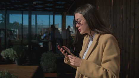 mujer usando teléfono inteligente al aire libre