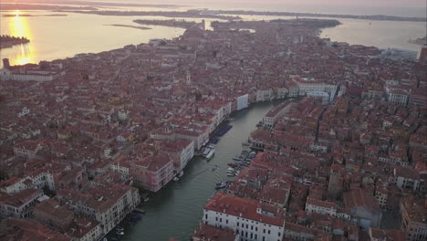 aerial shot following canal grande towards ponte di rialto, morning, venice, italy