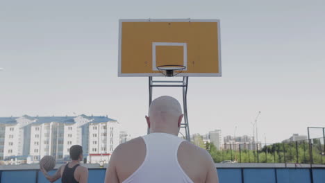 basketball players shooting hoops outdoors