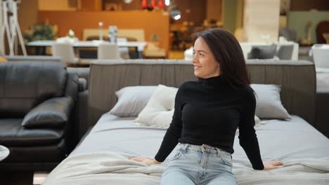 woman enjoying a cozy and comfortable moment on a modern bed among stylish furniture a chic and fashionable woman takes pleasure in a cozy and comforting moment on a modern bed amidst stylish furniture