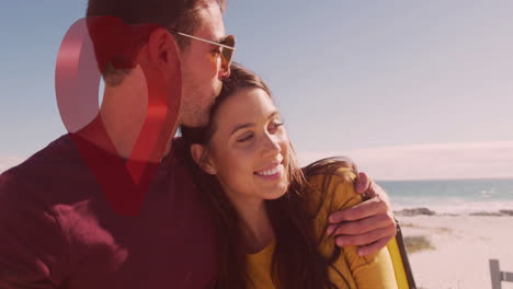 embracing couple on beach with heart animation overlay in romantic setting