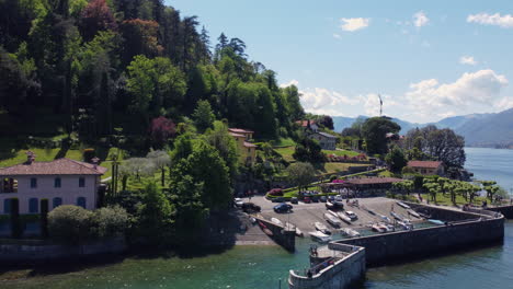 A-wide-aerial-shot-of-a-harbor-and-tourists-in-Lake-Como,-Italy