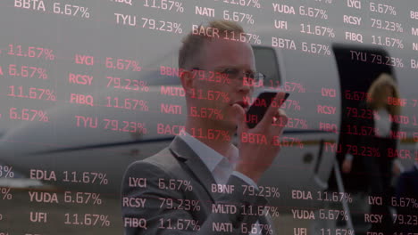 animation of stock market and diagrams over caucasian businessman talking on smartphone