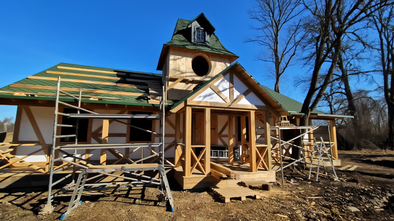House Under Construction With Scaffoldings And Ladder. - wide shot