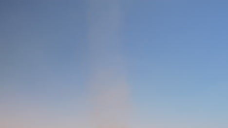 a tilt shot of a dust devil in the desert of morocco, in slow motion