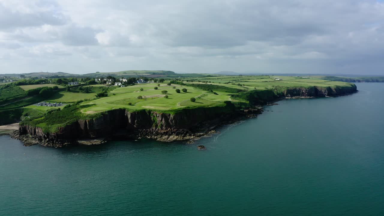 Rolling hills of Ireland's green coastline.