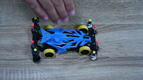 a blue modified racer picked up and dropped many times, tamiya mini 4x4