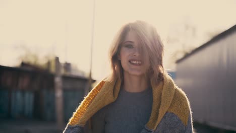 cu tracking portrait of smiling young beautiful girl against sun