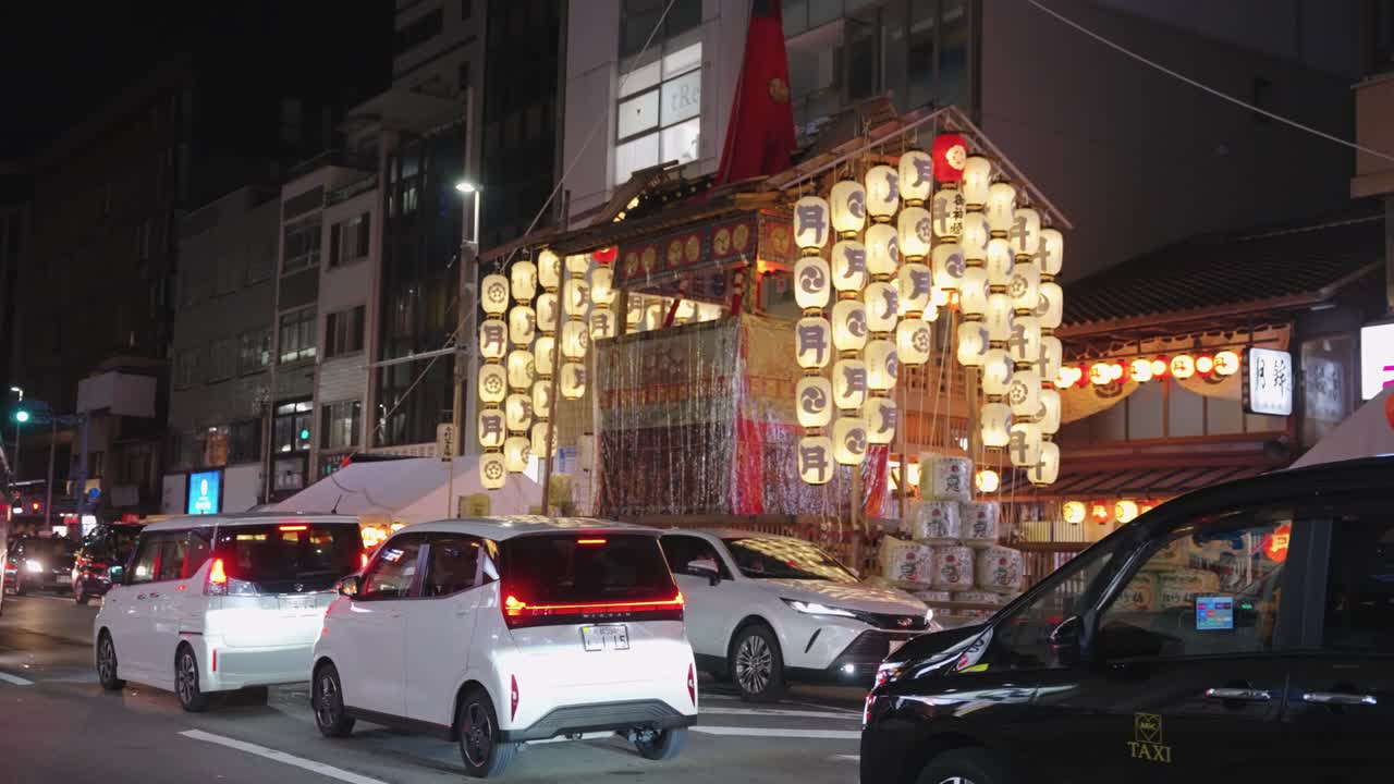 Night street scene in Japan with an illuminated festival float